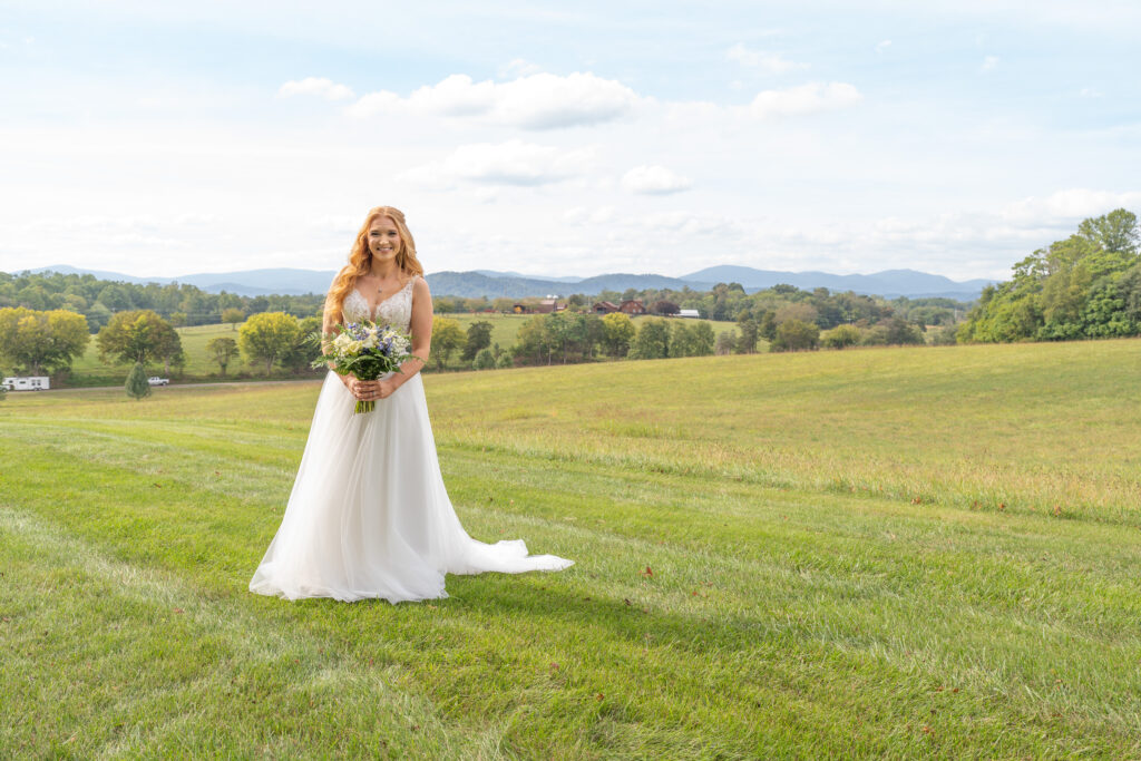 Bride smiling with her flowers at Renback barn