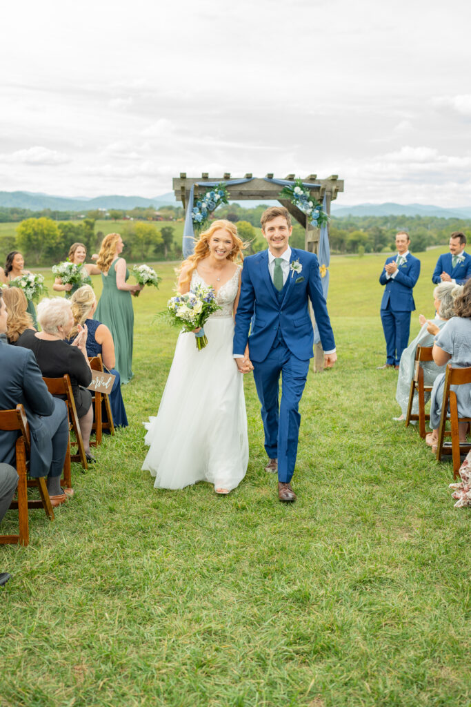 Bride and groom walking and smiling after getting married.