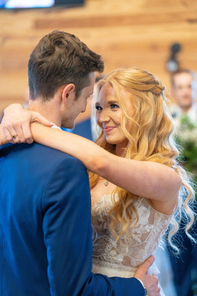 Bride hugs and dances with the groom on their wedding day.