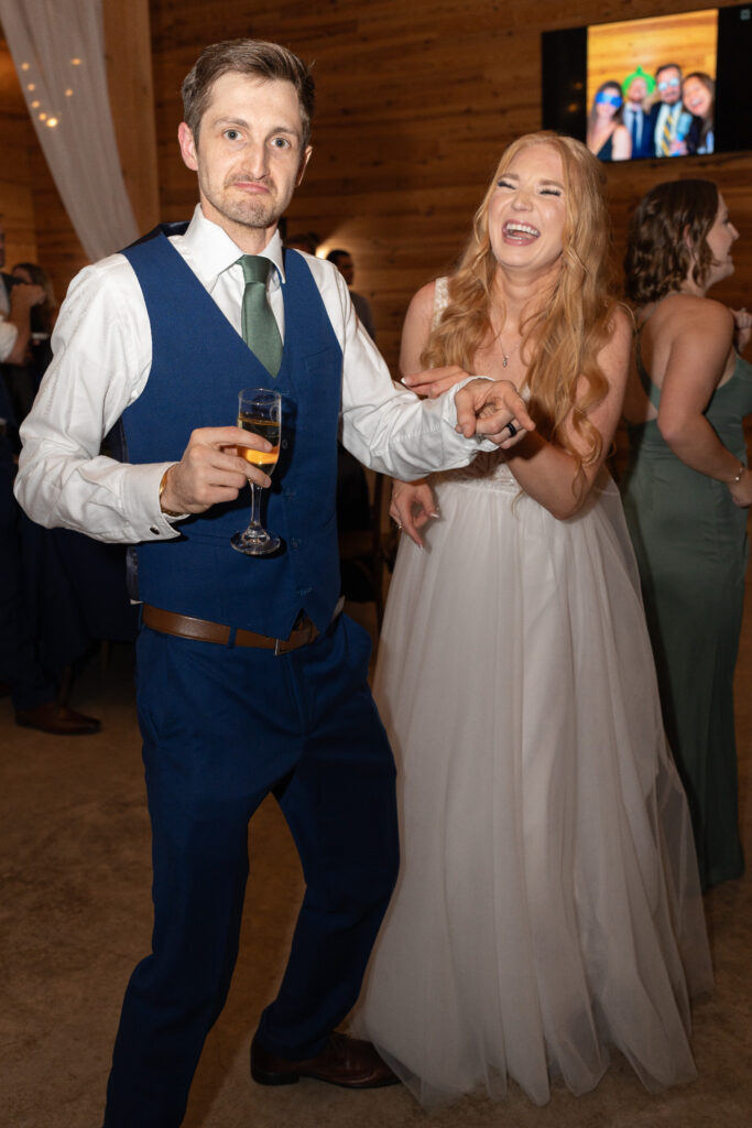 Bride and groom smile on camera.