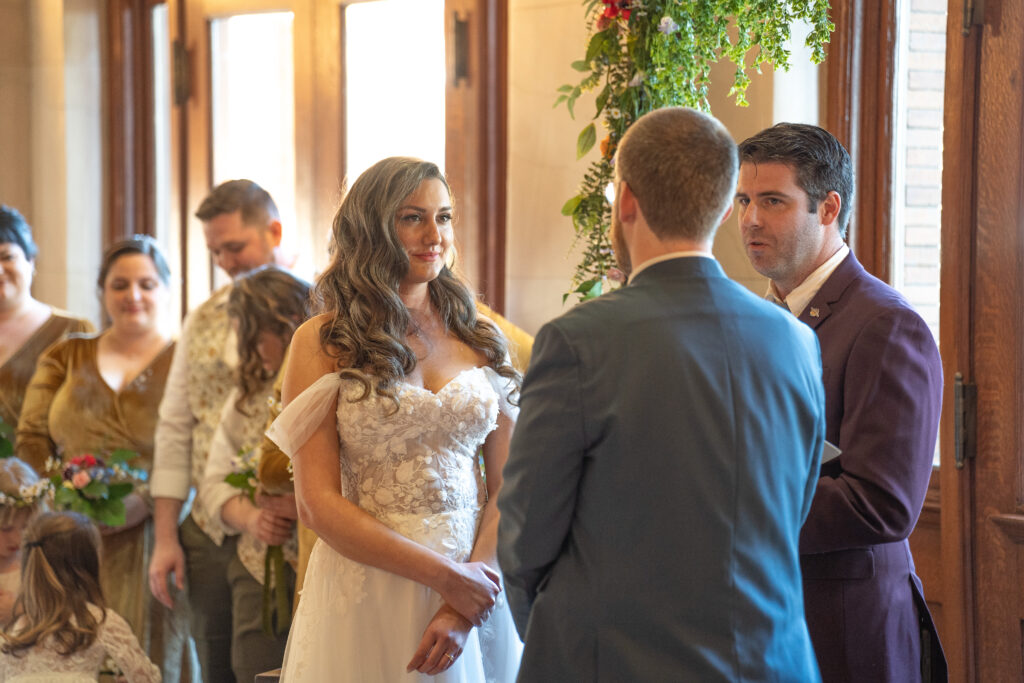 A bride smiles at her groom 