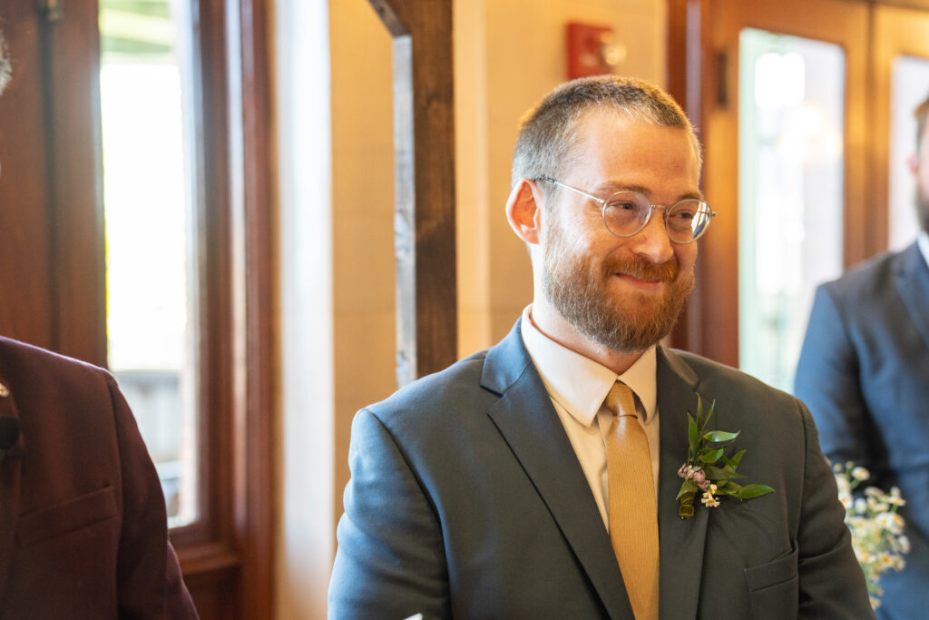 A groom smiling during his wedding ceremony at Main Street station In Richmond, Va.