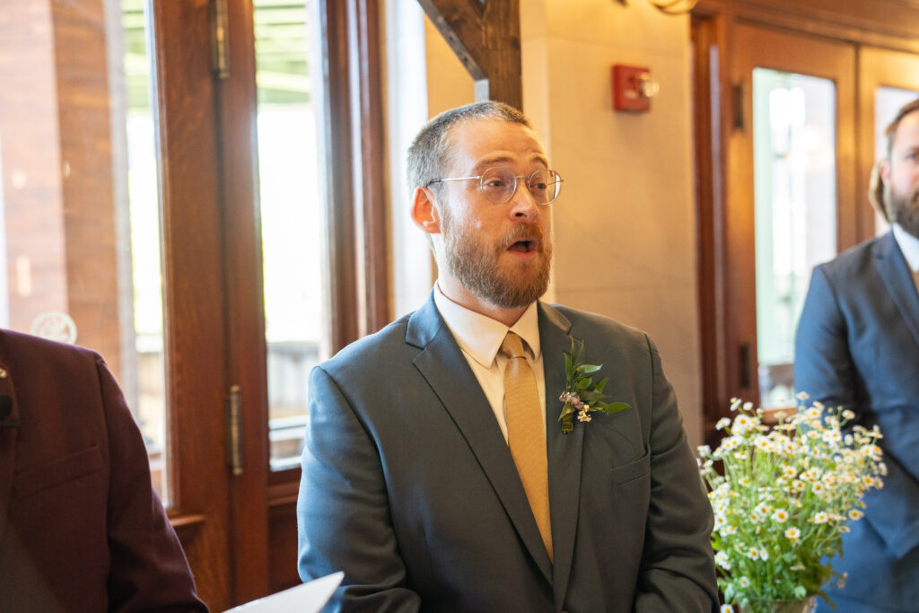 A groom at a Main Street Station with his mouth wide open in shock of how beautiful his wife looks on their wedding day.