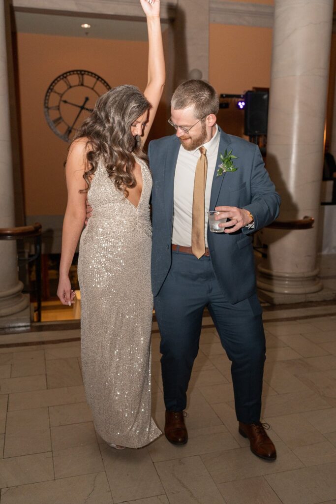 A bride and groom start dancing on the dance floor at their wedding reception at main street station in Richmond va 