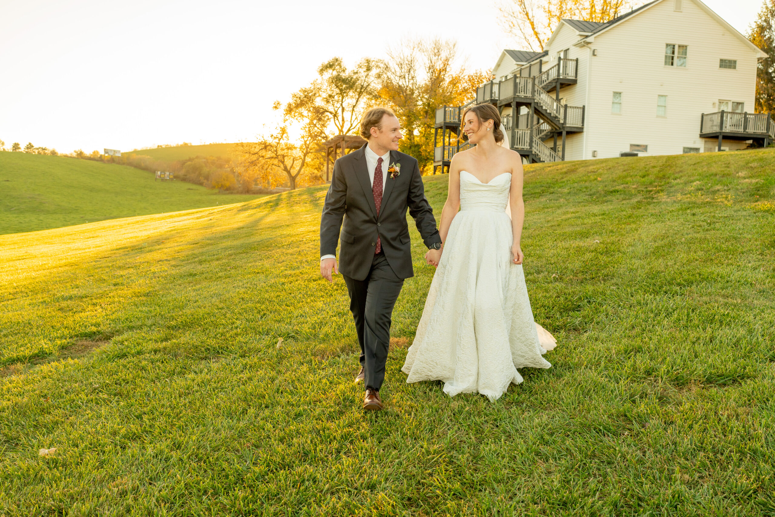 Bride and groom walking during golden hour at a Shenandoah wedding, captured in soft natural light by Richmond photographer Mason Jesmer