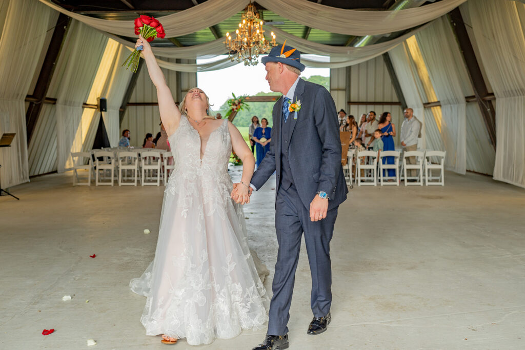 Barns of Kanak wedding - bride bouquet raise Metal Barn recessional